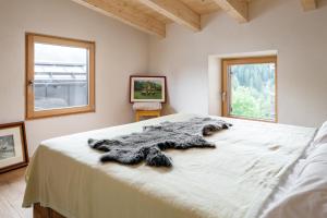 a bedroom with a bed with a fur blanket on it at La casa! in Vigo di Fassa