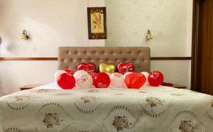 a group of red and white balloons on a bed at Hotel Villa Tafaj in Tirana
