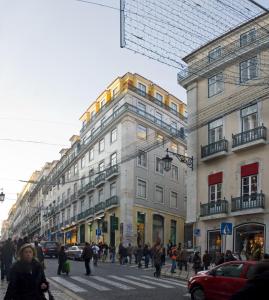 people walking down a city street at Lisbon Charming Apartments - Chiado in Lisbon