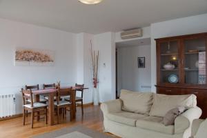 a living room filled with furniture and a table at Lisbon Charming Apartments - Chiado in Lisbon