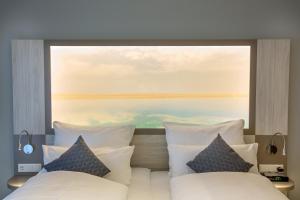 Postel nebo postele na pokoji v ubytování Nordsee Lodge + 31 fotografií