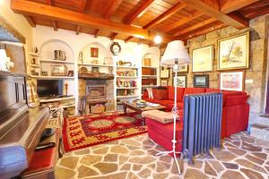 a living room with a red couch and a fireplace at Casa Os Curras in Culleredo