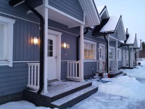 a row of houses with snow on the ground at ANNA - Modern flat with Sauna - 24h Check in in Närpiö