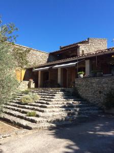 a brick house with a set of stone stairs at Le Verger in Gordes