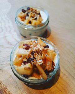 two bowls of food on a wooden table at Villa La Vida in Egmond aan Zee