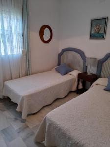 Кровать или кровати в номере Adosado en campo de golf Islantilla