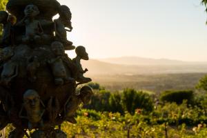 a statue with children sitting on it in a field of flowers at Amberg Country Estate in Paarl