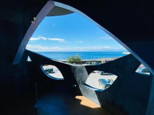 a view of the ocean from a room with a window at 綠島寧靜海潛水-城堡館 Twinkleocean diving hostel in Green Island