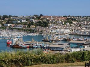 a group of boats docked in a harbor at Pilchard Cottage in Brixham