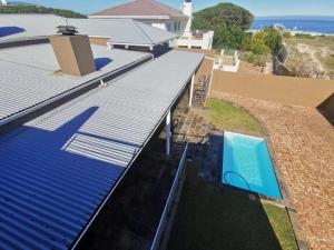 an overhead view of a house with a roof and a swimming pool at Brander View in Hermanus