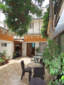 a patio with tables and chairs and a building at Hotel Baleares in Santiago