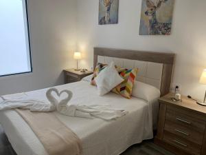 a bedroom with a bed with a swan decoration on it at Alojamientos Agaete Pueblo N11 in Agaete
