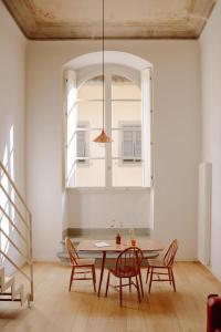 a dining room with a table and chairs and a window at Numeroventi Design Residency in Florence