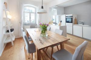 a kitchen and dining room with a wooden table and chairs at Ferienhaus Lemon Tree in Rieden