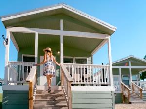 a woman walking down the stairs of a beach house at Sun Retreats Texas Hill Country in New Braunfels