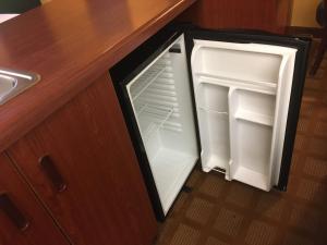an open refrigerator with its door open in a kitchen at Microtel Inn & Suites by Wyndham Hillsborough in Hillsborough