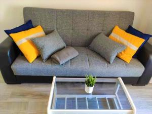 a couch with pillows and a coffee table in a living room at Eldorado Apartment La Mata in La Mata