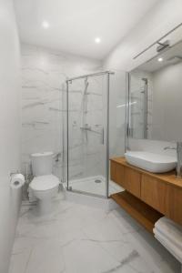 a bathroom with a shower and a toilet and a sink at Apartamenty Familijne in Kudowa-Zdrój +22 photos