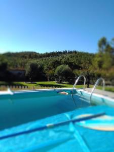 a swimming pool with a view of a golf course at Quinta Do Centro in Melriça