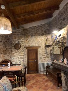 a dining room with a wooden table and a tableablish at Tenuta de Maffutiis in Polla
