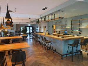 a bar in a restaurant with tables and chairs at Chalet Vechtdal in Mariënberg