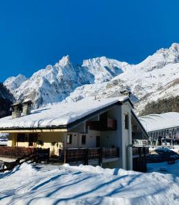 a snow covered ski slope with a mountain range at Shatush Hotel in Courmayeur