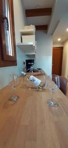 two wine glasses sitting on top of a wooden table at Andros 4 All Seasons Villas & Suites in Andros