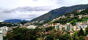 a city on a hill with buildings and mountains at Loft Dream Rest in Teresópolis