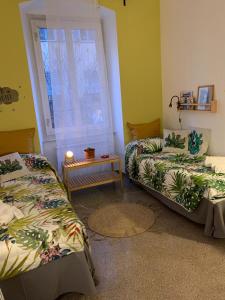 a room with two beds and a window at CASA IVO in Genoa