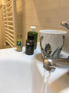 a cup sitting on a sink next to a faucet at CASA IVO in Genoa