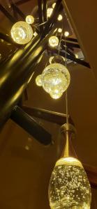 a group of lights hanging from a ceiling at Andros 4 All Seasons Villas & Suites in Andros