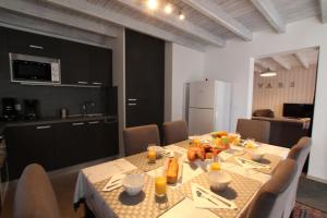 a dining room with a table and a kitchen at Chalet Changalan in Vars