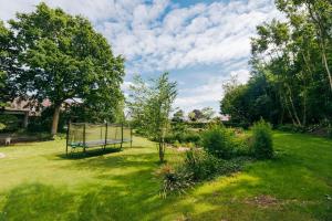 a garden with a basketball hoop in the grass at Family friendly - Give apartment in Billund
