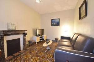 a living room with a couch and a fireplace at Le Martin Pêcheur in Port-en-Bessin-Huppain