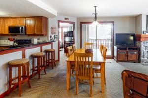 a kitchen and dining room with a table and chairs at Eagle Springs East 201: Horsetail Suite in Burnt Flat