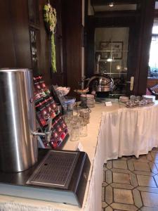 a table with a white table cloth and a counter with food at Hotel Zur Linde in Lauf