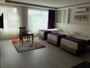 Ein Bett oder Betten in einem Zimmer der Unterkunft Prime Boutique Hotel