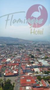 una vista aérea de una ciudad con un cartel de hotel en HOTEL FLAMINGOS DE CIUDAD GUZMAN, en Ciudad Guzmán