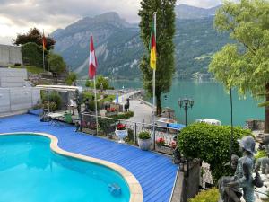 a swimming pool with a view of a lake and mountains at Holiday Apartment Alpenblume in Brienz