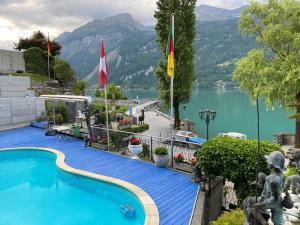a swimming pool with a view of a lake and mountains at Alpenblick - Direct lake view in Brienz