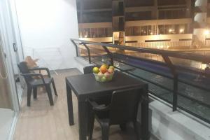 a table with a bowl of fruit on top of a building at Condominio vacacional Paraiso del Sol, San Jeronim in San Jerónimo