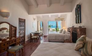 a bedroom with two beds and a desk and a window at Rancho Las Cruces in Las Cruces