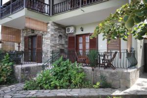 a house with chairs and a balcony at GORGONA VILLAS in Vourvourou