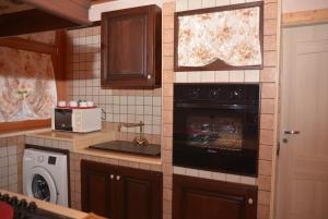 a kitchen with a stove and a stove top oven at VILLA DEI CICAS in Taranto +8 photos