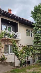 a house with a balcony on the side of it at Apartmani Smiljanic app 3 in Soko Banja