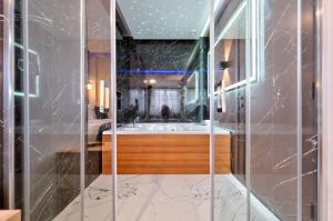 a bathroom with a tub and a shower with marble at Hotel Aria in Užice +119 photos