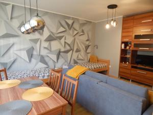 a living room with a blue couch and a table at Boros Apartman in Kőszeg