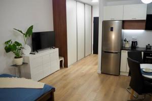 a kitchen with a stainless steel refrigerator in a room at Studio Nr 4 close to Medicover and Paley Institute in Warsaw