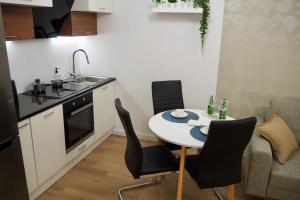 a kitchen with a table and chairs in a kitchen at Studio Nr 4 close to Medicover and Paley Institute in Warsaw
