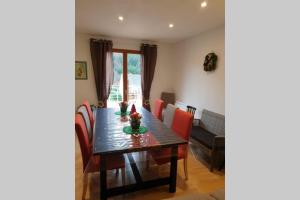 a dining room with a table with chairs and a dining room at Chalet Loulou, massif central, Le Mont-Dore in Le Mont-Dore +29 photos
